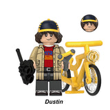 Dustin Henderson custom toy minifigure, Lego-compatible Stranger Things figure with yellow bike.
